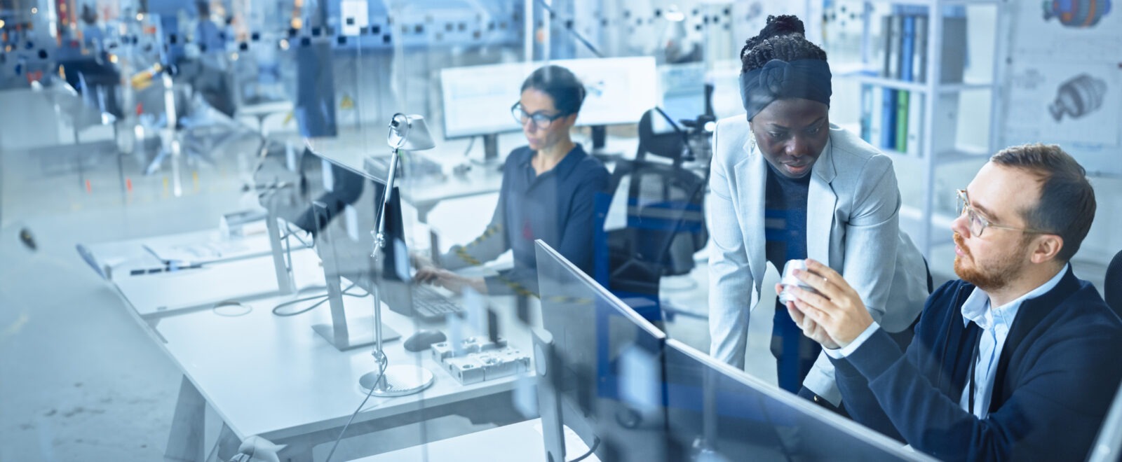 A team of professionals in front of computer workstations