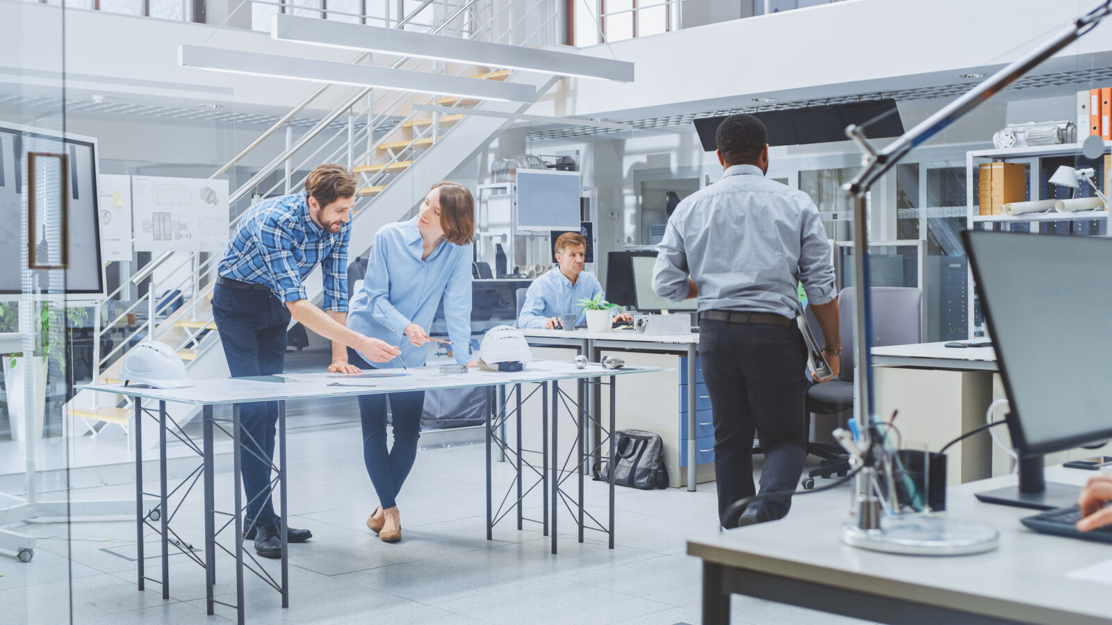 A team of engineers collaborating over a document